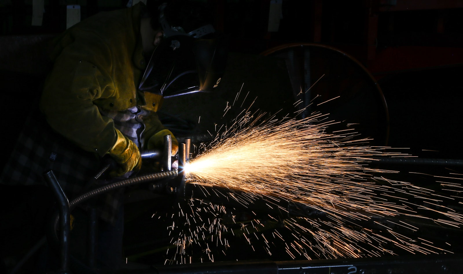 A welder at work in a small fabrication shop.