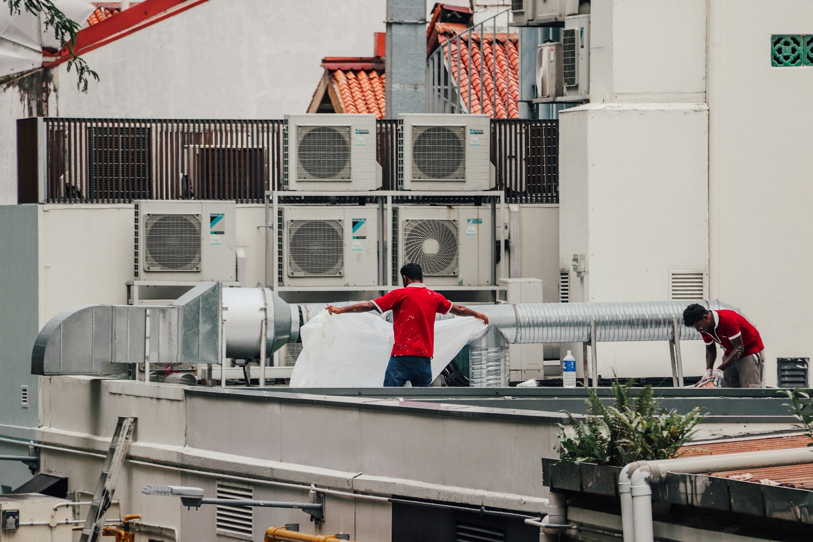 HVAC crew working on a rooftop unit